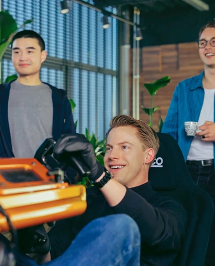 employees having fun with formula 1 racing simulator